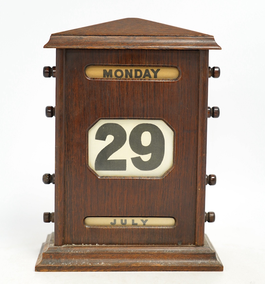 An early 20th century oak perpetual calendar, 19cm wide, 26cm high. Condition - fair